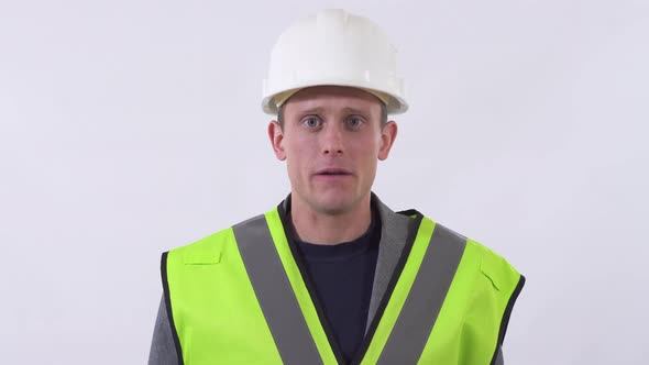 Portrait of Builder in Uniform Speaking and Looking in the Camera