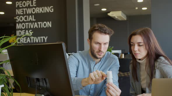 Male Engineer Showing Detail to Female Colleague