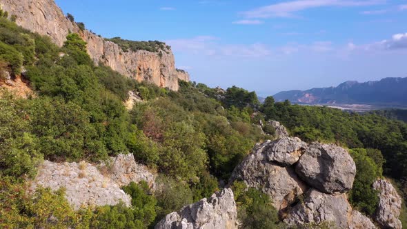 Aerial View of Huge Rocky Formations on a Forested Mountains Slopes