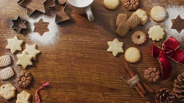 Video of christmas decorations with cookies and copy space on wooden background