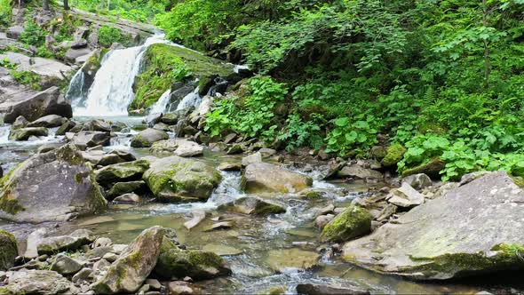 Mountain River Waterfall Flowing Between Rocky Shores in Carpathians Mountains Ukraine