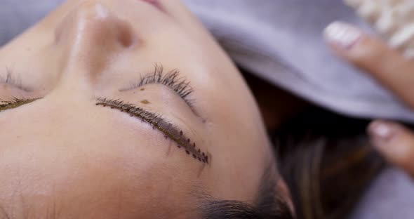 Young woman gets facial beauty procedure, microblading procedure