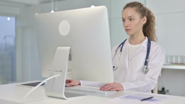 Portrait of Ambitious Young Female Doctor Working on Desk Top