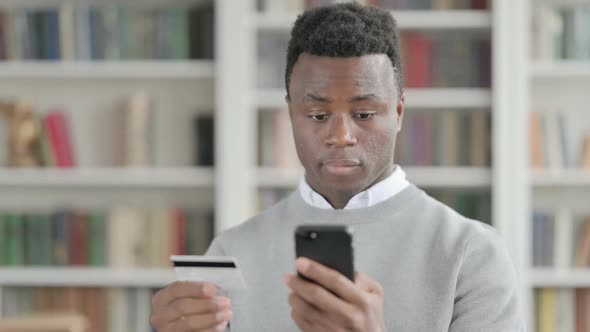 Portrait of African Man Making Online Payment on Smartphone