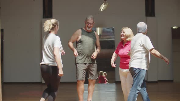 Long Shot of Happy Senior Men and Women Dancing in Ballroom