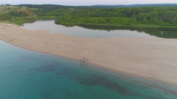 Group of Young People, Tourists at Sand Beach Stripe with Turquoise Sea Water