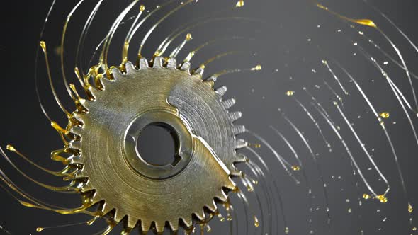 Super Slow Motion Shot of Rotating and Splashing Metal Cogwheel on Dark Background at 1000 Fps