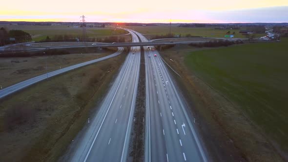 Freeway Road with Moving Cars Between Green Fields