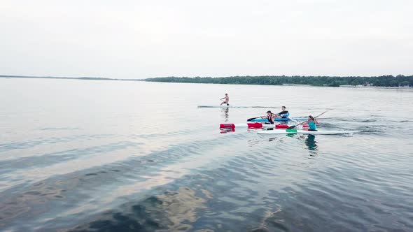 Well-coordinated Team Kayaking on Lake