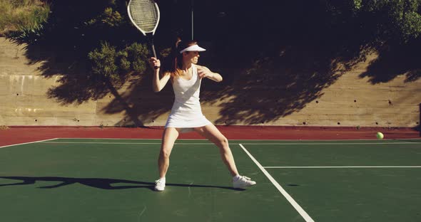 Woman playing tennis on a sunny day