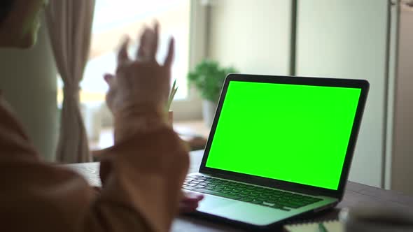 Mature Woman End Video Call Online Conversation on Laptop with Green Screen Say Goodbye and Wave