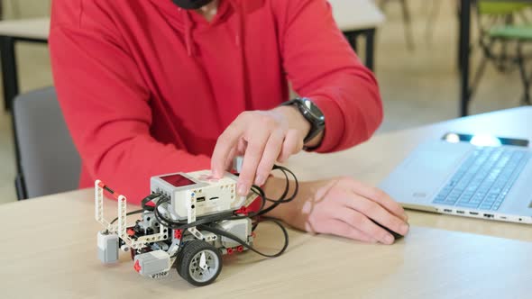 Robotics Teacher Who Teaches an Online Course for His Students Using a Computer