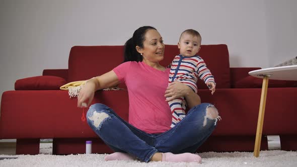 Attractive Latin Mother Blowing Bubbles with Baby