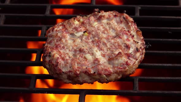 Closeup of the Burger Cutlet Made of Meat and Onions Roasting on the Grill