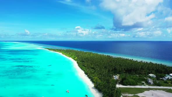 Aerial top down landscape of tranquil island beach adventure by blue water with bright sand backgrou