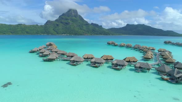 Aerial drone view of a luxury resort and overwater bungalows in Bora Bora tropical island