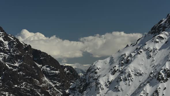 Time lapse of clouds moving over rugged mountains