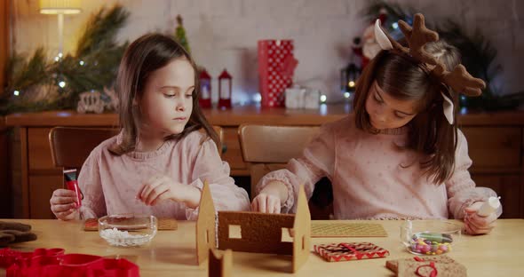 Two Cute Sisters Build Decorate Christmas Gingerbread House