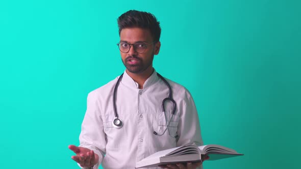 Indian Bearded Cardiologist Man with Eyes Glasses in White Medical Coat with Stethoscope in Blue