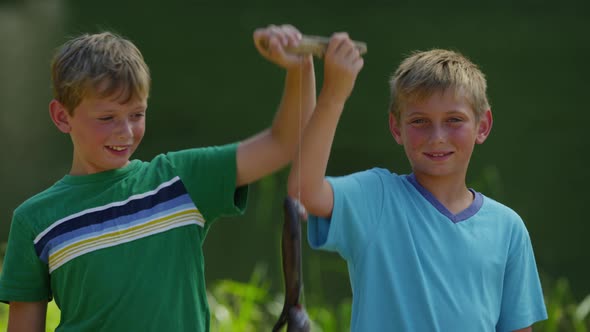 Boys holding up fish