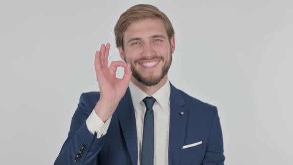 Young Businessman with Ok Sign on White Background