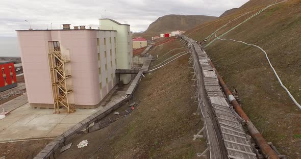 Drone Flight Over the Pipe Stretching By the Ground Along the Settlement of Barentsburg. Spitsbergen