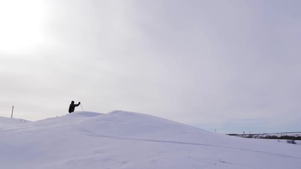 Silhouette of Skier Jumping on Mountain Ski Slope