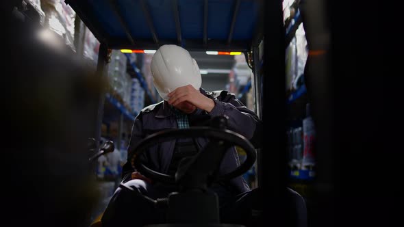 Stressed Sad Caucasian Warehouse Loader Taking Off Hard Hat Leaving Broken Vehicle