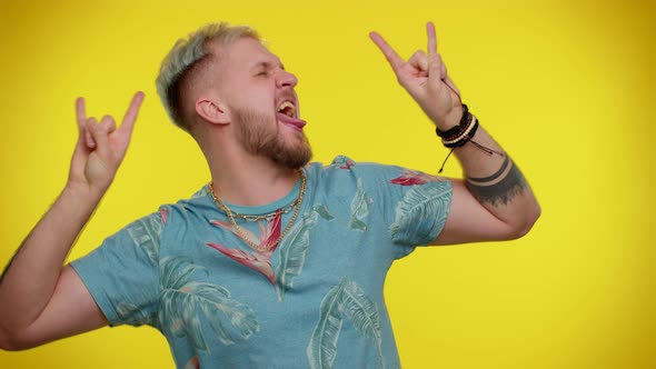 Overjoyed Tourist Man Showing Rock n Roll Gesture By Hands Cool Sign Shouting Yeah with Crazy Face