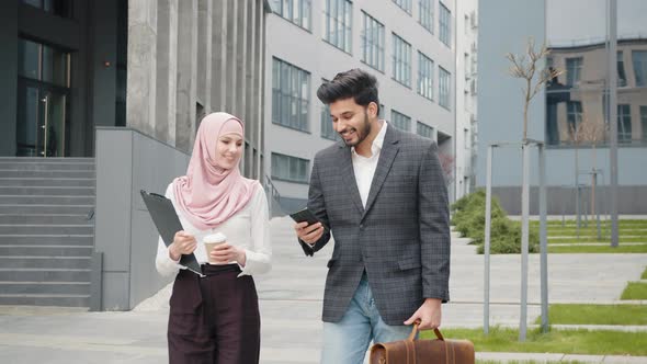 Arabian Business Colleagues in Formal Clothes Walking on Street and Discussing