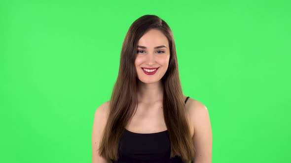 Woman Standing, Spreads Out in a Smile and Looks at the Camera. Green Screen