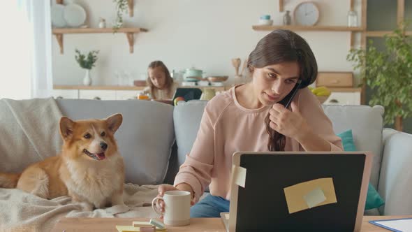 Busy Annoyed Mother Working Remotely With a Laptop and Doing Business