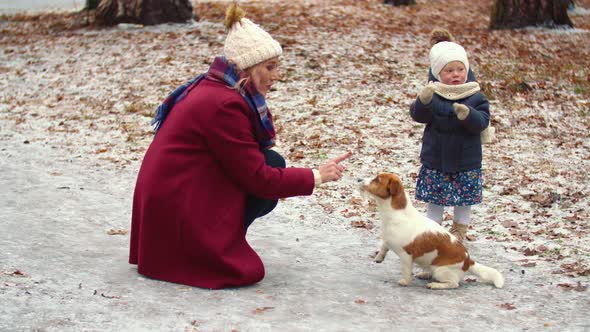Mom with Daughter and Dog in the Park