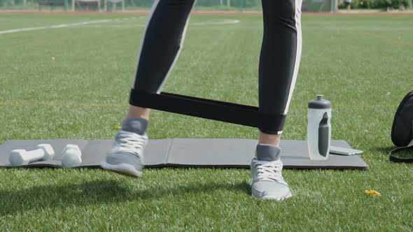 Woman Doing Workout Exercises with Elastic Rope Band