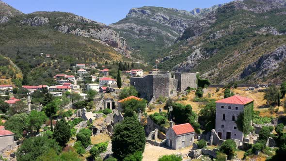 Scenic aerial 4k shot of the coastal city of Bar in Montenegro and the old Stari Bar fortress in the