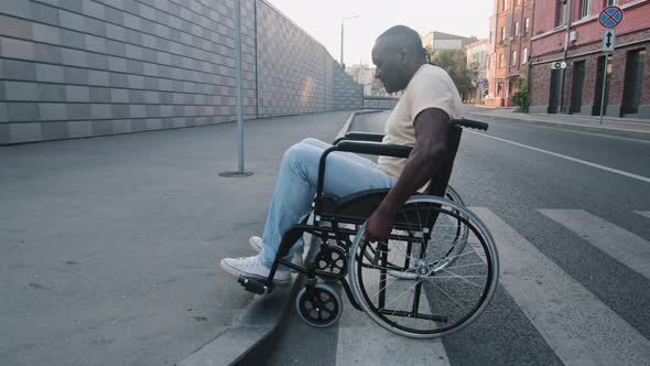 Elderly Black African Disabled Person Crosses Road and Tries Unsuccessfully to Climb Onto Sidewalk