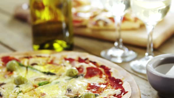 Delicious pizza with a glass of wine and spices