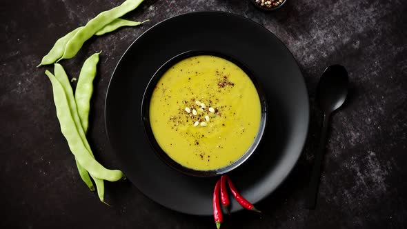 Creamy Soup with Green Pea in a Ceramic White Plate