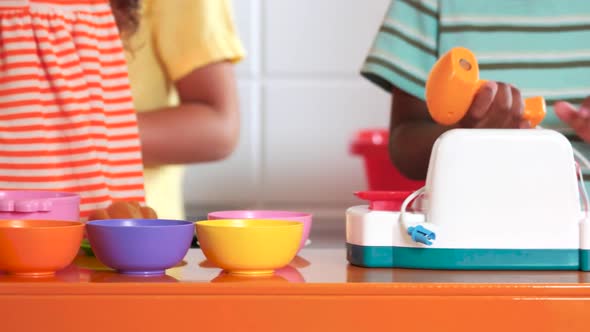 Close Up Children Play with Toy Kitchen Set