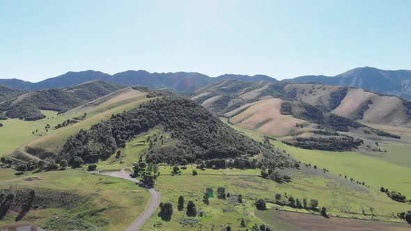 Green Utah Hills and Mountains in the Summer with a Dirt Road Aerial Drone View 4K