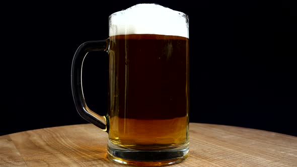 Glass of beer on a black background.