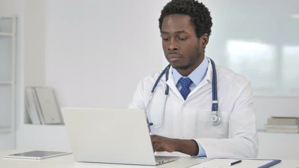 African Doctor Working On Laptop
