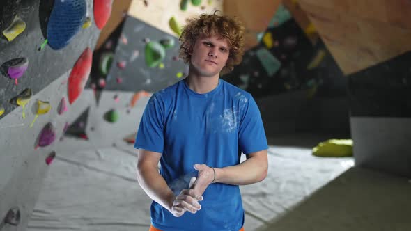 Portrait of a Young Man Climber Looking Into the Camera a Sporty Man Stands Against the Background