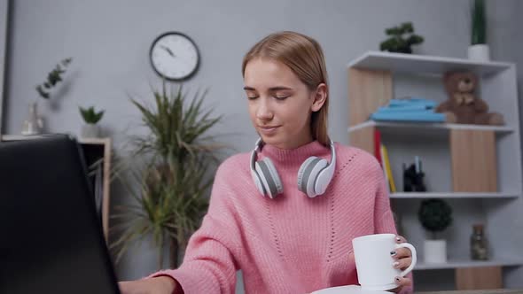 Blond Woman in Pink Sweater which Looking at the Computer