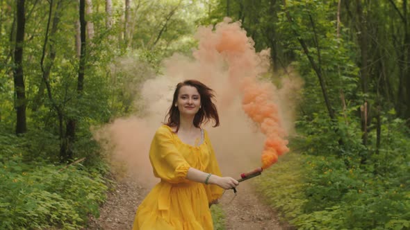 Joyful Woman Whirling in Clouds of Color Smoke