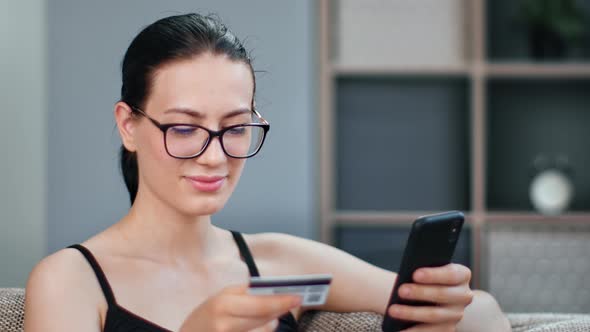 Pleasant Mixed Race Woman Paying Card Use Online Smartphone Application Enjoying Internet Shopping