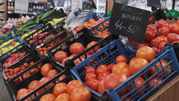 Vegetable Department in a Supermarket. Containers with Tomatoes with Price Tags