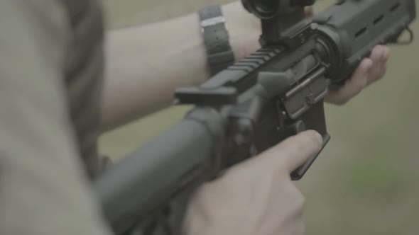 Rifle in the Hands of a Shooter During Shooting. Slow Motion. Close-up.