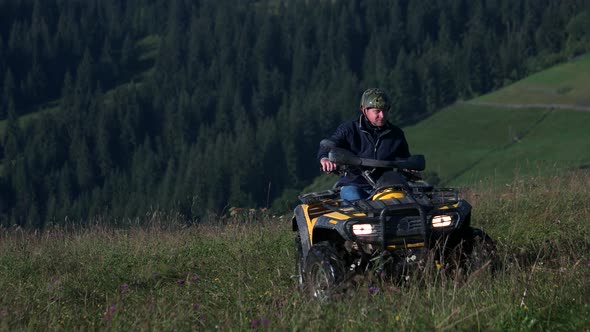 Two Men Riding Quad Bikes in the Mountains