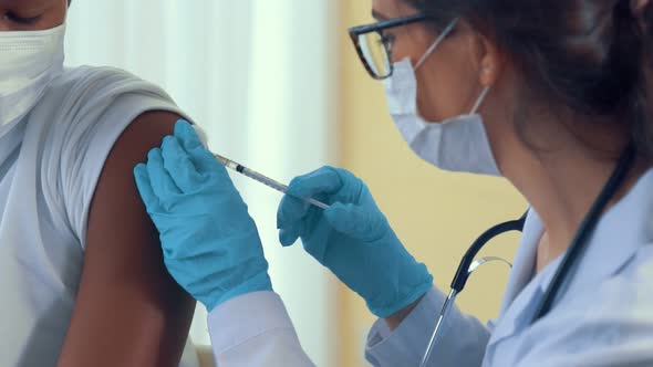 Young Man Visits Skillful Doctor at Hospital for Vaccination